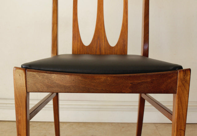Set of four vintage G-Plan Brasilia teak dining chairs with black leather seats and slender mid-century British design,.