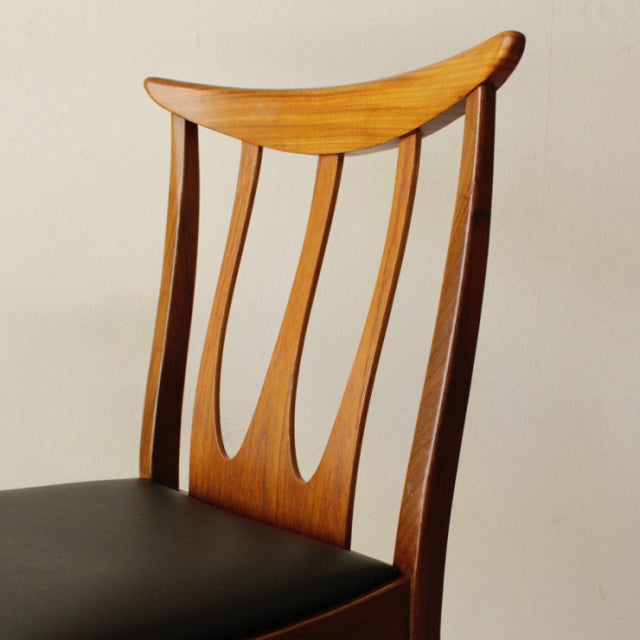 Vintage G-Plan teak dining chair with British mid-century design, curved backrest and slender vertical slats, black.