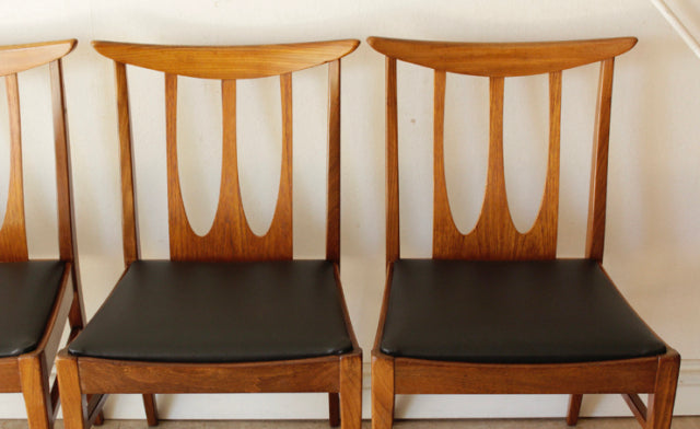 Set of four vintage British mid-century G-Plan dining chairs in teak with curved backs and black upholstered seats,.