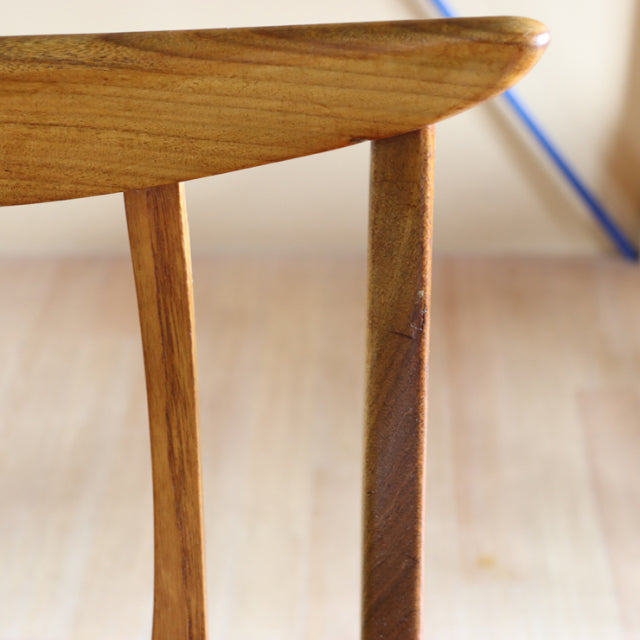 Close-up of vintage teak G-Plan Brasilia dining chair backrest showing smooth wood grain and mid-century British design with .