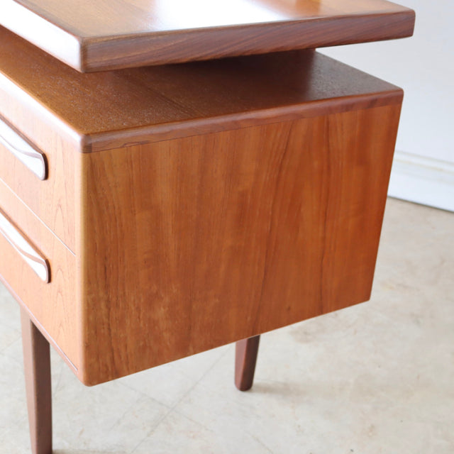 Vintage G-plan teak desk drawer with smooth grain, mid-century British design, slender tapered legs.