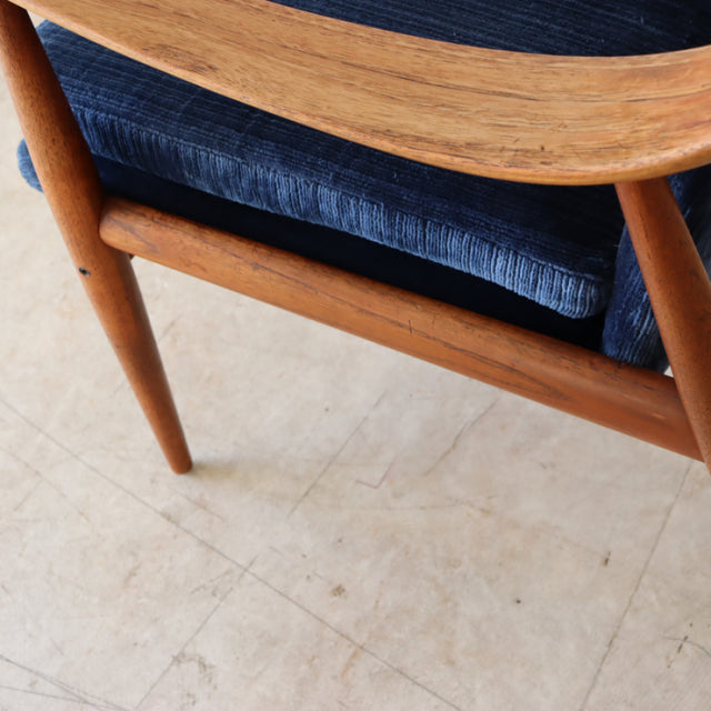 Mid-century vintage teak chair leg and frame with smooth wood grain and dark blue upholstered seat from Denmark.