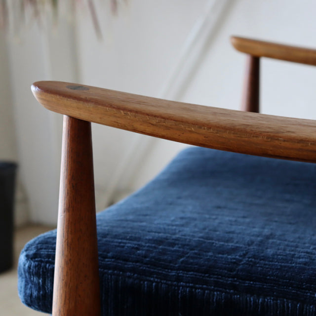Mid-century vintage teak armrest detail on Peter Hvidt & Orla Molgaard-Nielsen Denmark sofa with blue fabric upholstery.