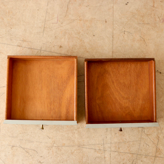 Pair of vintage British mid-century teak bedside cabinet drawers with smooth wood grain and clean lines.