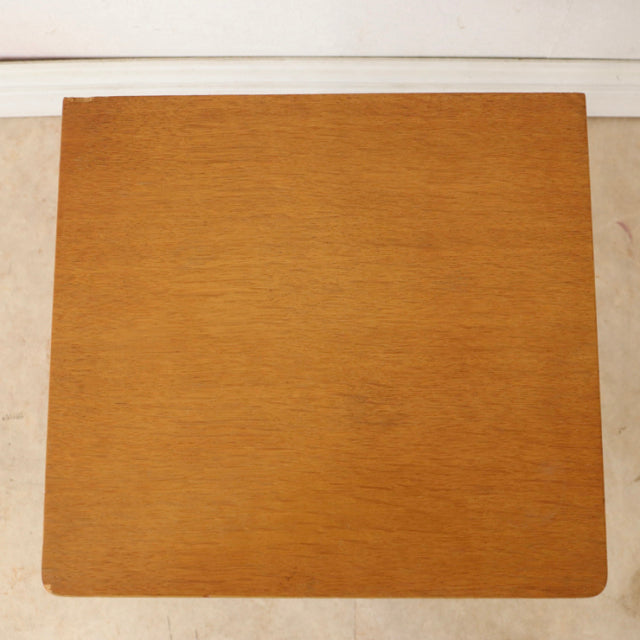 Square teak bedside cabinet with smooth wood grain and rounded edges, mid-century British vintage style.