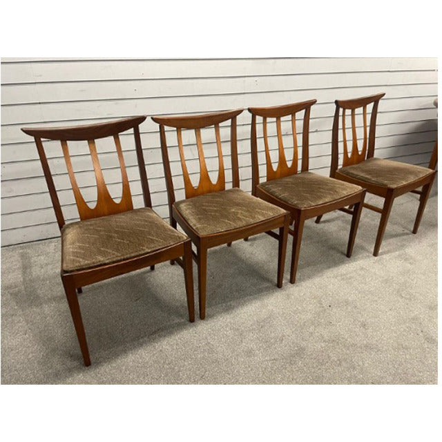 Set of four vintage G-Plan mid-century teak dining chairs with curved backs and slender spindled legs, showcasing British.