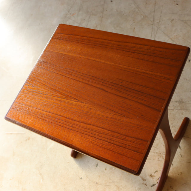 Vintage British mid-century G-Plan teak nest table with rich wood grain and slender angled legs.
