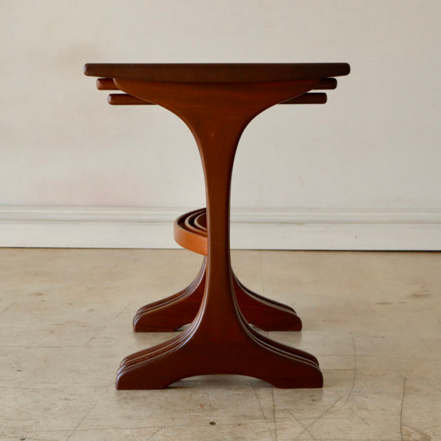 Vintage teak G-Plan British mid-century nest tables with curved legs and smooth wood grain finish.