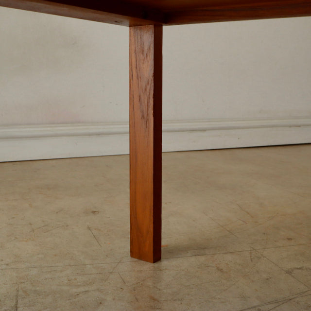 Mid-century British vintage teak coffee table leg with rich wood grain and clean rectangular profile.