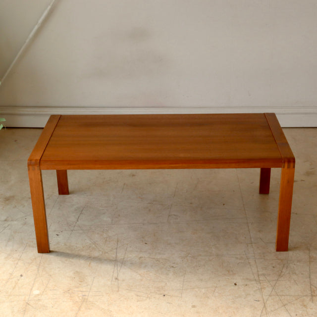 Mid-century British vintage teak coffee table with clean lines, straight legs, and rich wood grain from Denmark.