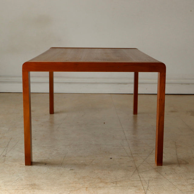 Mid-century British vintage teak coffee table with clean lines, square legs, and smooth wood grain finish.