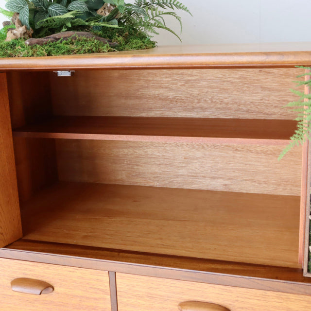 Mid-century British vintage teak G-Plan sideboard with open shelving, smooth wood grain, and rounded edges.