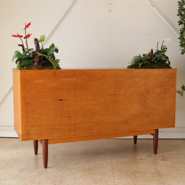 Vintage teak G-Plan sideboard with mid-century British design, sleek wood grain, and tapered legs.