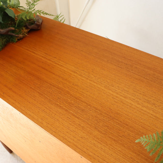 Vintage British G-Plan teak sideboard top showcasing mid-century Denmark-inspired wood grain and smooth finish.