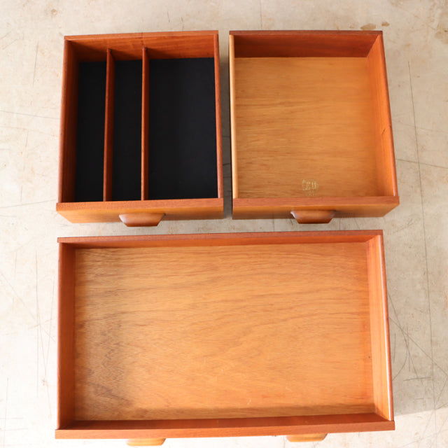 Three vintage teak drawers with visible wood grain and rounded handles from British mid-century G-Plan sideboard.