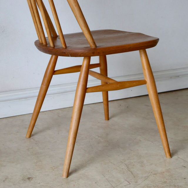 Vintage ERCOL mid-century teak Quaker chair with angled legs and curved spindle back, British design.