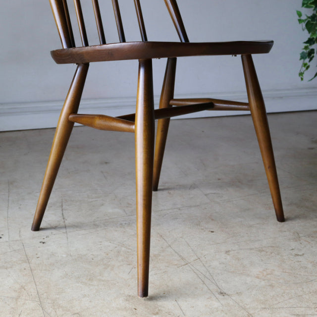 Vintage British Arcol Quaker dining chair in teak with mid-century tapered legs and visible wood grain.