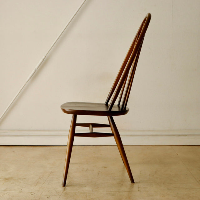 Vintage British Ercol Quaker chair in teak with mid-century slender spindle back and tapered legs.