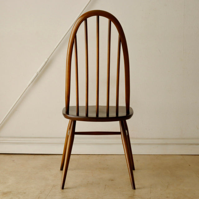 Vintage British mid-century Ercol Quaker chair in teak with arched spindle back and tapered legs.