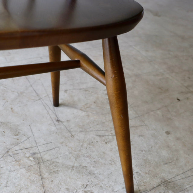 Mid-century British Ercol Quaker chair leg in warm vintage teak with smooth grain and slender rounded taper design.