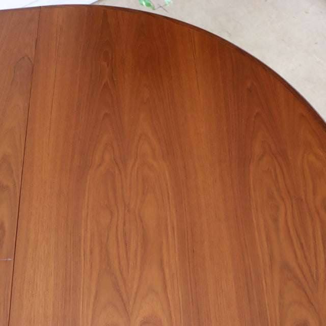 Vintage G-Plan mid-century teak dining table with rich wood grain and smooth rounded edges, British design with elegant.