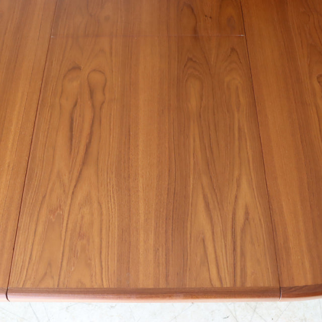 Vintage British mid-century teak dining table from G-Plan Fresco series with smooth wood grain and rounded edges.