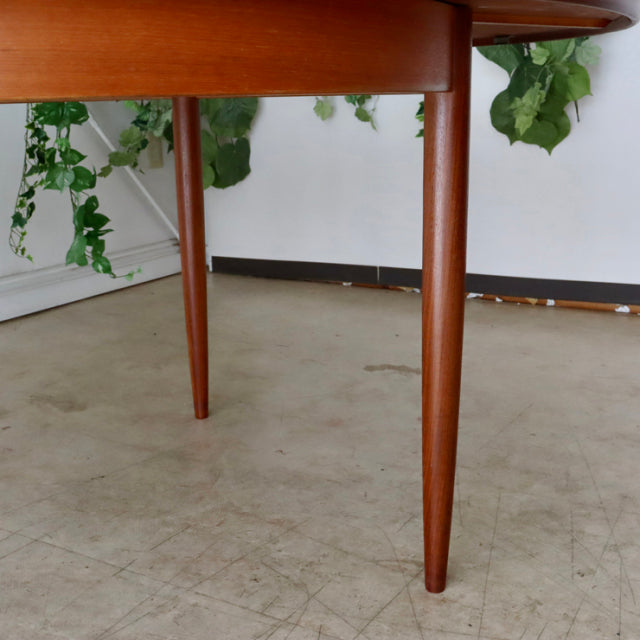 Mid-century British G-Plan vintage teak dining table leg with tapered design and warm wood grain finish.