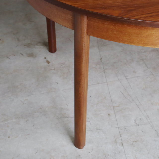 Mid-century vintage teak dining table leg with smooth wood grain and tapered rounded form, British-Denmark style.