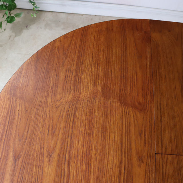 Round vintage teak dining table top with rich wood grain, mid-century Danish-British design.