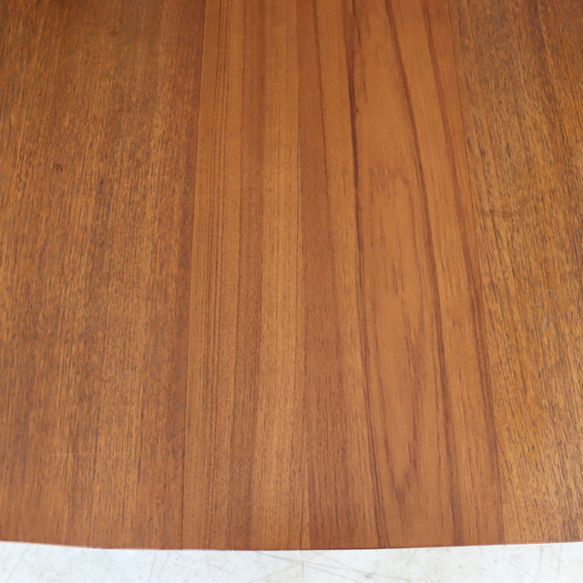 Mid-century vintage British teak dining table top with rich wood grain and warm brown tones.