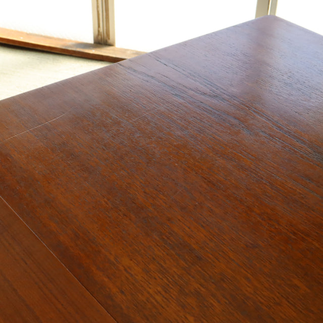 Vintage mid-century British teak dining table with rich wood grain and smooth rectangular top, showcasing Denmark-inspired.