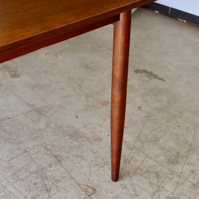 Vintage teak dining table leg with smooth grain, mid-century British design, tapered cylindrical form from Denmark style.