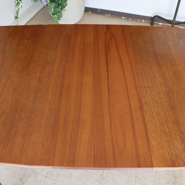 Mid-century British vintage teak dining table with rich wood grain and smooth rectangular top.