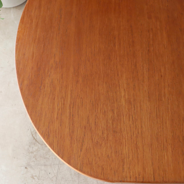 Vintage teak oval dining table top showcasing warm wood grain and smooth edges, mid-century British design.