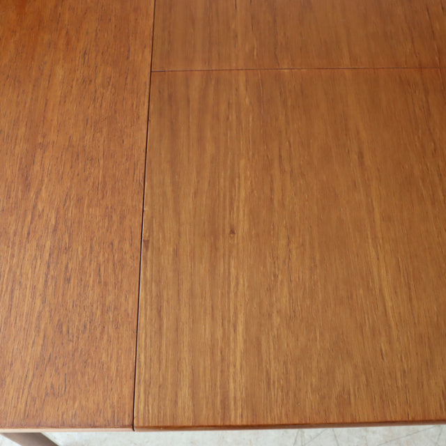 Oval mid-century vintage teak dining table top showing rich wood grain and smooth finish.