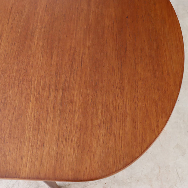 Oval vintage teak dining table top with smooth wood grain, British mid-century Danish design.