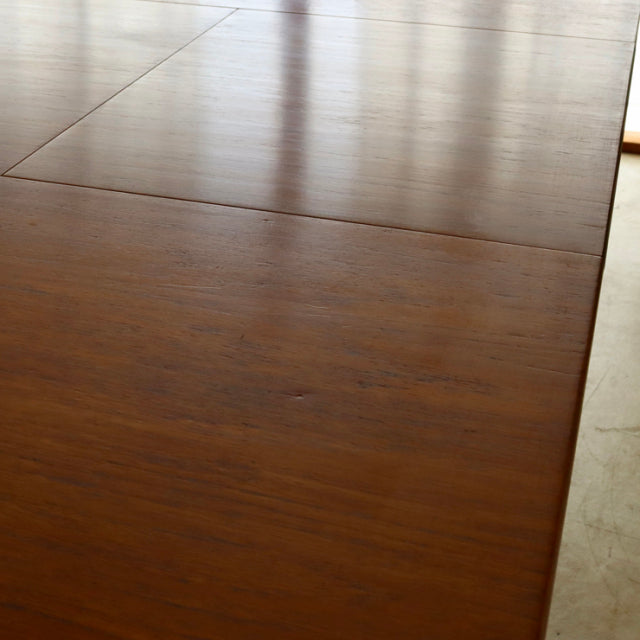 Oval vintage teak dining table with smooth grain, British mid-century design, slender legs, Danish style craftsmanship.