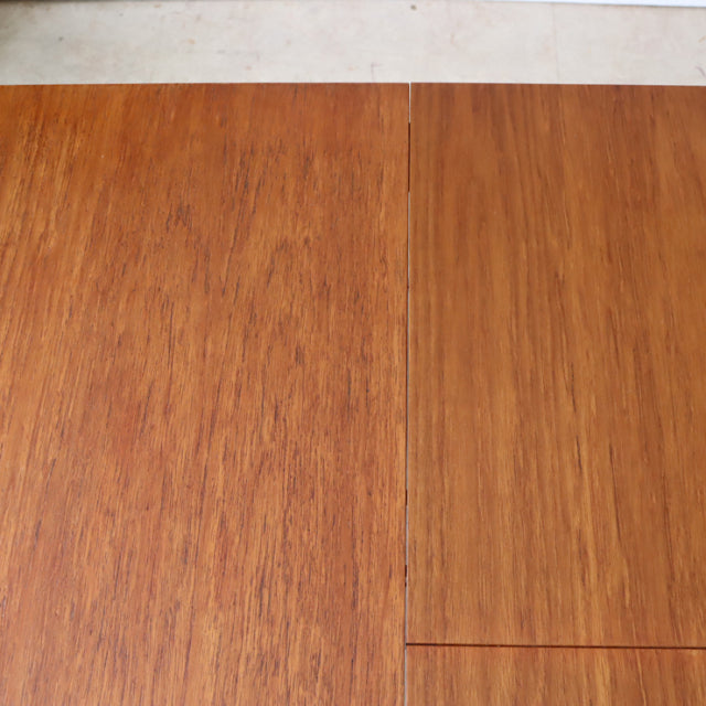 Vintage teak dining table top with rich wood grain and subtle mid-century British craftsmanship.