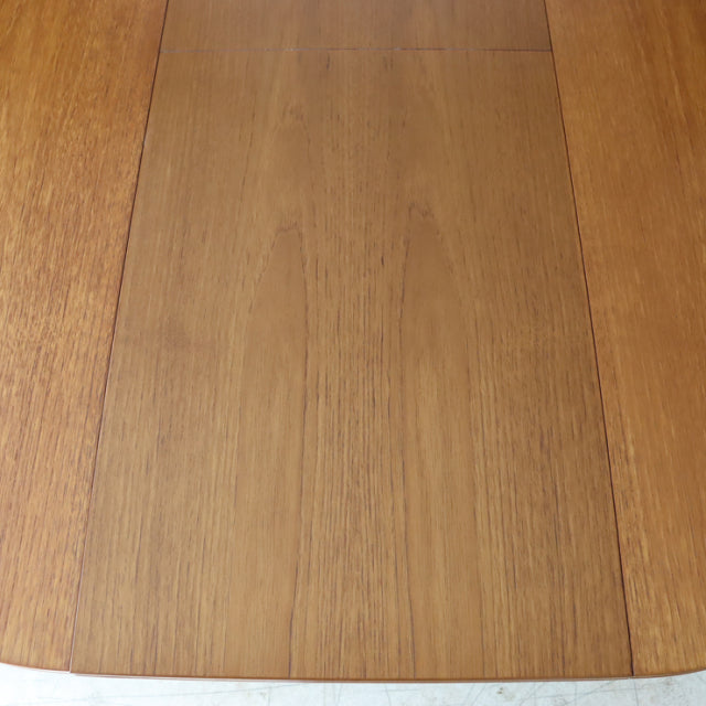 Vintage mid-century teak dining table top with fine wood grain and smooth finish, British design.