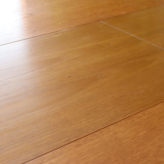 Mid-century British teak dining table by Greaves and Thomas with smooth grain and oval edges.