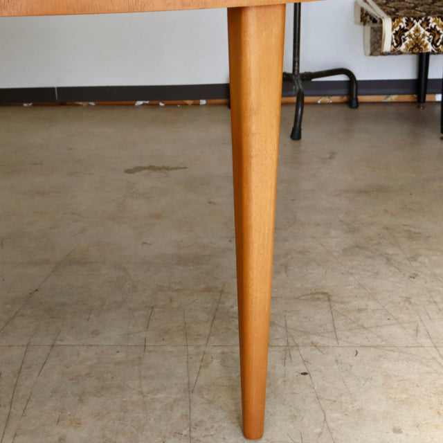 Mid-century vintage teak dining table leg by GREAVESandTHOMAS with smooth wood grain and tapered design.