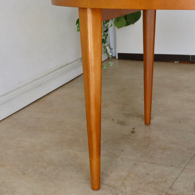 Mid-century teak dining table leg with warm wood grain, tapered British design by Greaves and Thomas.