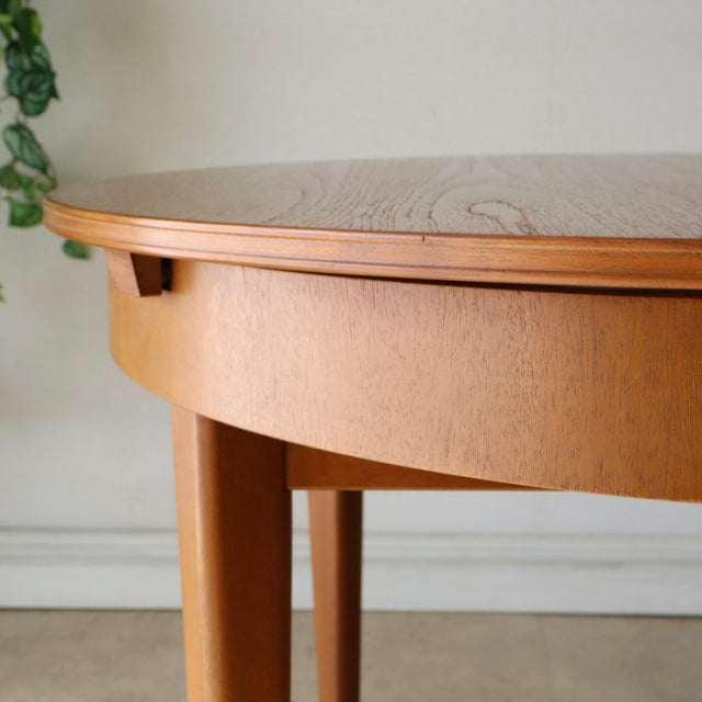 Vintage teak dining table by GREAVESandTHOMAS with smooth rounded edge and tapered mid-century British design legs.
