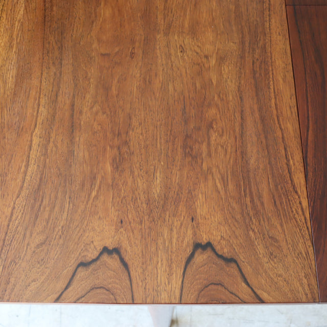 Vintage mid-century teak dining table top with rich wood grain and warm British or Danish design influences.