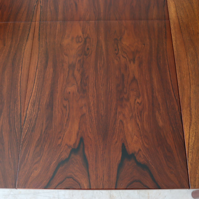 Vintage teak dining table top showcasing rich wood grain with warm mid-century British design details.
