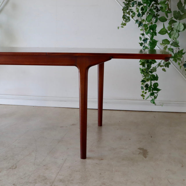 Vintage mid-century McIntosh teak dining table with smooth grain and slender tapered legs, British and Denmark inspired.