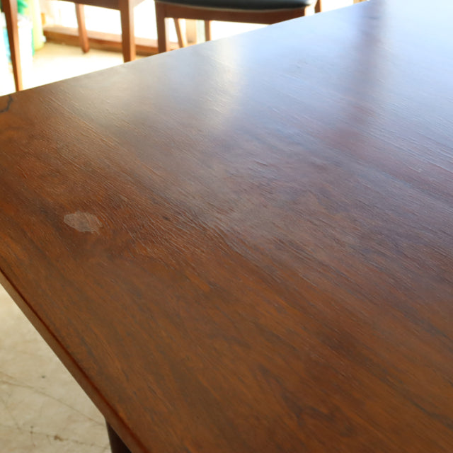 Vintage McIntosh teak dining table with rich wood grain, mid-century British design, rectangular top and tapered legs.