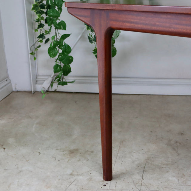 Mid-century British teak dining table leg with smooth grain and rounded edges, vintage McIntosh design from Denmark style.