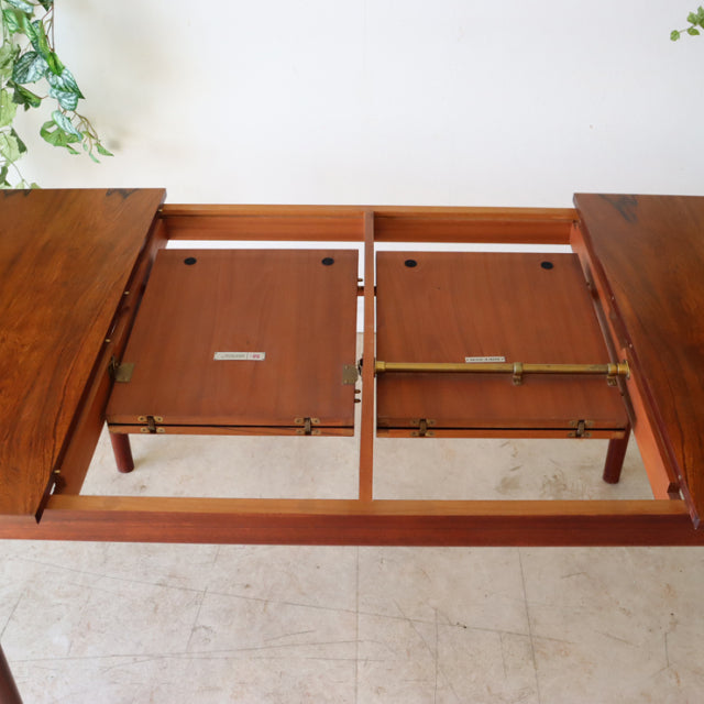 Vintage mid-century McIntosh teak dining table with extension mechanism and rich wood grain, British-Danish design.
