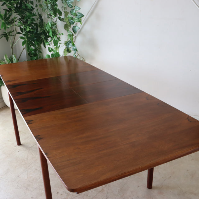 Vintage mid-century teak dining table by McIntosh with rich wood grain and slender tapered legs, showcasing British and.